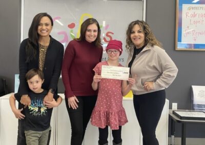 5 people with donation check for GiGi's playhouse Sacramento